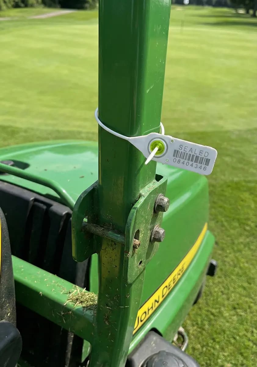 TurfWise machinery tag attached to a John Deere mower